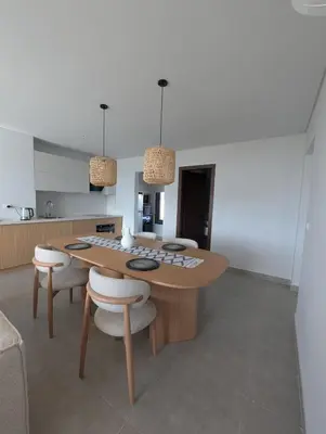 a kitchen with a wooden table and chairs at New Modern Boutique 2BR - Sunset & Sea views in Hurghada