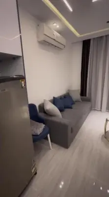 a living room with a couch and a blue chair at Humbra in Hurghada