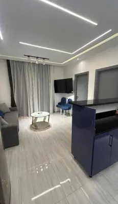 a living room with a grand piano and a couch at Humbra in Hurghada