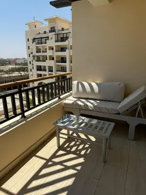 a couch sitting on a balcony with a table at Lotus Al-Dau Heights in Hurghada