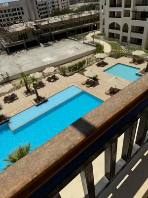 a view of the pool from the balcony of a hotel at Lotus Al-Dau Heights in Hurghada