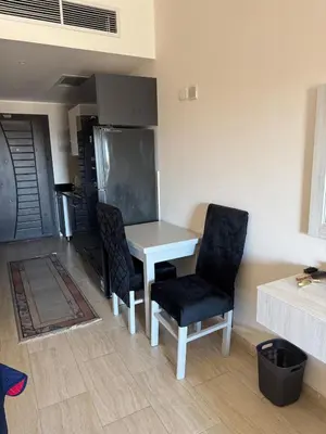 a kitchen with a white table and two chairs at Lotus Al-Dau Heights in Hurghada