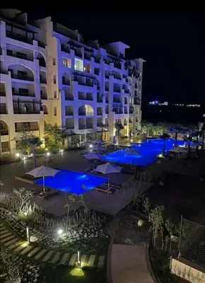 a hotel with blue lights in front of a building at Lotus Al-Dau Heights in Hurghada