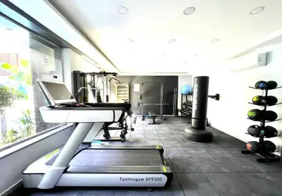 a treadmill in a gym with a laptop on it at Imperial Resort App 433 in Hurghada