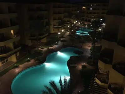 an overhead view of a swimming pool at night at Modern Apartment in the Britsh Resort in Hurghada