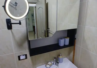 a bathroom with a sink and a mirror at Modern Apartment in the Britsh Resort in Hurghada