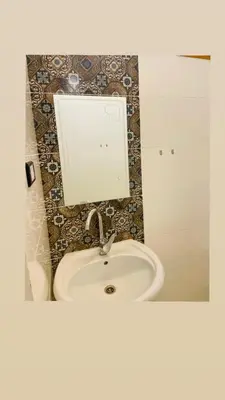 a bathroom with a sink and a mirror at In Luxor in Luxor