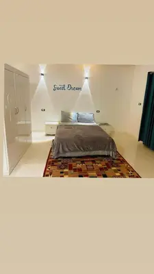 a bedroom with a bed with a sign that reads sweet dream at In Luxor in Luxor