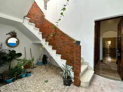 a brick staircase in a house with potted plants at In Luxor in Luxor