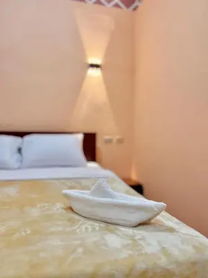 a hotel room with a white towel on the bed at Aswan City Center Hotel in Aswan