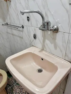 a white sink in a bathroom with a toilet at Aswan City Center Hotel in Aswan