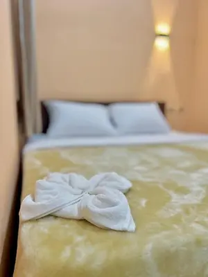 a bed with two towels sitting on top of it at Aswan City Center Hotel in Aswan