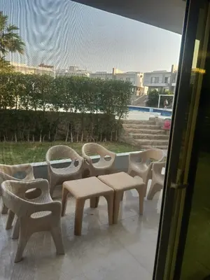 a row of chairs and tables in front of a window at Sky Star Villa 97 in Hurghada