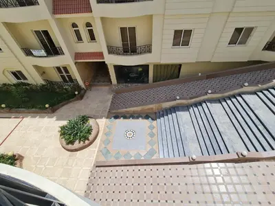 an aerial view of a building with a swimming pool at Stunning One-Bedroom Apartment at the prestigious Palm Beach Piazza in Hurghada