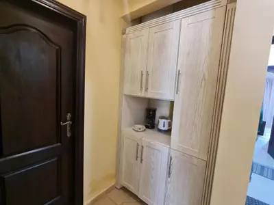 a room with wooden cabinets and a door and a room at Stunning One-Bedroom Apartment at the prestigious Palm Beach Piazza in Hurghada