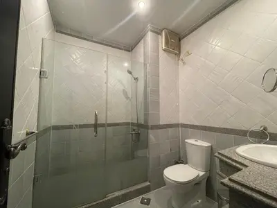 a bathroom with a shower and a toilet and a sink at Stunning One-Bedroom Apartment at the prestigious Palm Beach Piazza in Hurghada