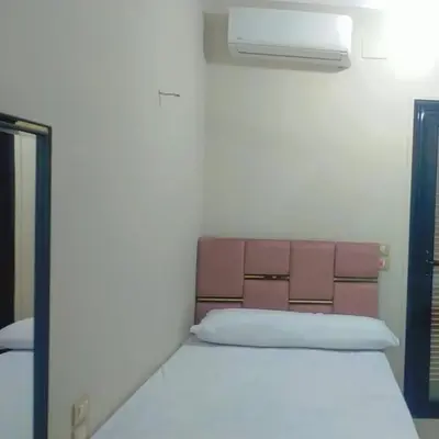 a white bed in a room with a window at happy apartment in Luxor