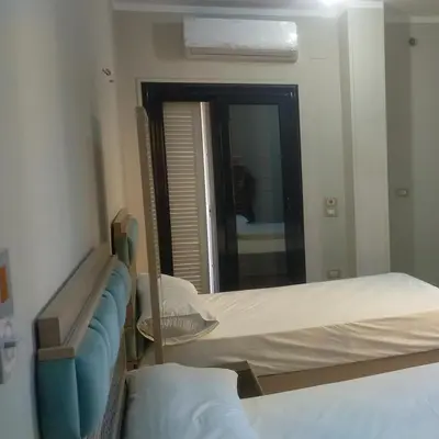 a hospital room with two beds and a mirror at happy apartment in Luxor