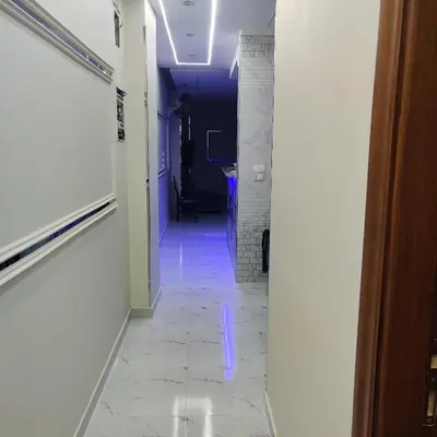 a hallway with a blue light on the floor at Appartement 2 slaapkamers in Hurghada