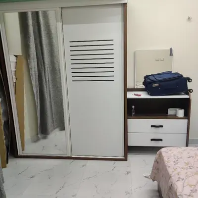 a sliding glass door in a bedroom with a mirror at Appartement 2 slaapkamers in Hurghada