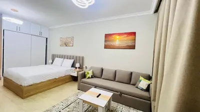 a small room with a bed and a couch at Luxury apartment pool view in Hurghada