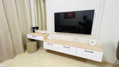 a flat screen tv sitting on top of a dresser at Luxury apartment pool view in Hurghada