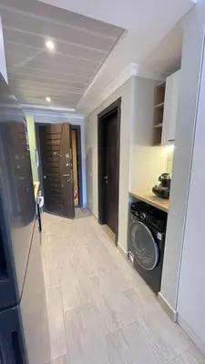 a kitchen with a washer and dryer in a room at Luxury apartment pool view in Hurghada