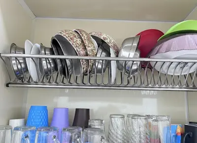a rack of dishes and glasses in a refrigerator at Hobby live in Hurghada in Hurghada