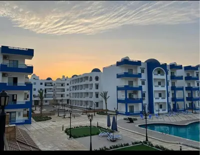 a view of a large apartment complex with a pool at اوسيس مارينا in Hurghada