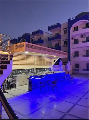 a building with a table and chairs in front of it at اوسيس مارينا in Hurghada