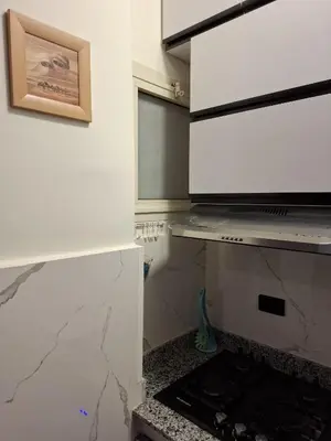 a kitchen with white walls and a counter top at Cozy flat in Makadi Heights in Hurghada