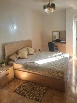a bedroom with a bed and a chandelier at Apartman v Hurgade 2 izbovy , v rezorte Florenza,plne zariadeny in Hurghada