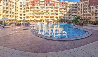 a large swimming pool in front of a large building at Apartman v Hurgade 2 izbovy , v rezorte Florenza,plne zariadeny in Hurghada