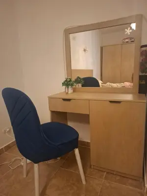a blue chair in front of a desk with a mirror at Apartman v Hurgade 2 izbovy , v rezorte Florenza,plne zariadeny in Hurghada
