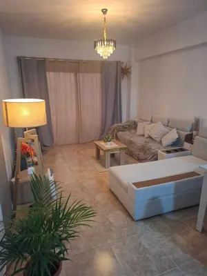 a living room with a couch and a table at Apartman v Hurgade 2 izbovy , v rezorte Florenza,plne zariadeny in Hurghada