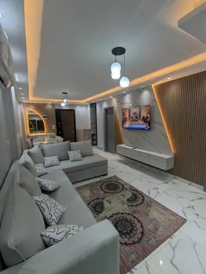 a living room with a couch and a tv at Avin Resort in Hurghada