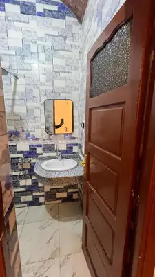 a bathroom with a sink and a door at Sheba Kato in Jazīrat Aswān