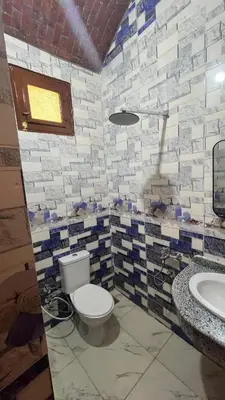 a bathroom with a toilet and a sink at Sheba Kato in Jazīrat Aswān