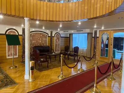 a living room with a table and chairs and a room with ropes at nile crouse in Luxor