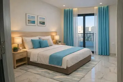 a bedroom with a large bed with blue pillows at 4S Icon Suites in Hurghada