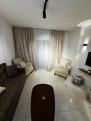 a living room with a couch and chairs in a room at Hurghada Apartment in Hurghada