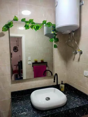a bathroom with a white sink and a mirror at Hurghada Apartment in Hurghada