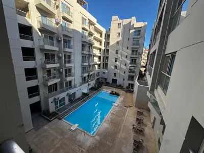 an overhead view of a swimming pool between two buildings at Hurghada Apartment in Hurghada