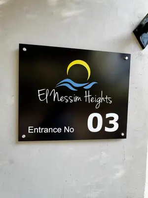 a sign on a wall that reads eastern heights entrance no at Hurghada Apartment in Hurghada