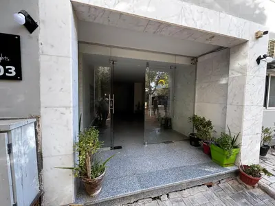 an entrance to a building with potted plants at Hurghada Apartment in Hurghada
