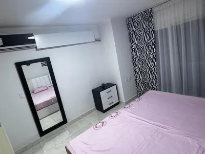 a bedroom with a pink bed and a mirror at Hurghada Apartment in Hurghada