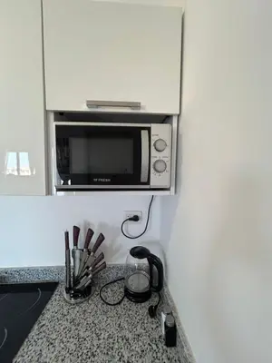 a kitchen counter with a microwave on top of it at Aqua Infinity Hurghada in Hurghada
