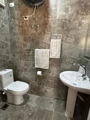 a bathroom with a toilet and a sink at Aqua Infinity Hurghada in Hurghada