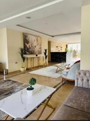 a living room with a couch and a table at Aqua Infinity Hurghada in Hurghada