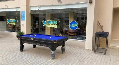 a pool table sitting in front of a building at Aqua Infinity Hurghada in Hurghada